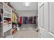 Large walk-in closet with built-in shelving and hanging rods for optimal storage space at 6131 Sparkling Cove Ln, Buford, GA 30518