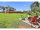 A spacious yard featuring an outdoor fire pit and Adirondack chairs perfect for entertaining guests at 110 Sunflower St, Tyrone, GA 30290