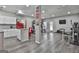 Finished basement with kitchen, gym equipment, and laminate flooring at 110 Sunflower St, Tyrone, GA 30290