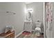 A well-lit bathroom featuring a white vanity, toilet, and a decorative mirror at 110 Sunflower St, Tyrone, GA 30290