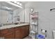 Bathroom featuring a granite countertop, wood cabinetry, and a chrome rack for storage at 110 Sunflower St, Tyrone, GA 30290