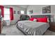 A well lit bedroom with decor, gray carpet, two windows, and a queen bed at 110 Sunflower St, Tyrone, GA 30290