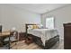 Cozy bedroom featuring a wooden bed frame, a soft color palette, and a functional work space at 110 Sunflower St, Tyrone, GA 30290