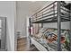 Bedroom with a bunk bed, wood flooring, and a peek into an adjacent room at 110 Sunflower St, Tyrone, GA 30290