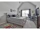 Cozy bedroom with vaulted ceilings, plush carpet, and a comfortable bed with decorative pillows at 110 Sunflower St, Tyrone, GA 30290