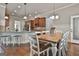 Open-concept kitchen and dining area with granite counters, stainless appliances and a rustic wood dining table at 110 Sunflower St, Tyrone, GA 30290