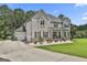 Large two-story home featuring an attached three-car garage and inviting front porch at 110 Sunflower St, Tyrone, GA 30290