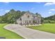 Spacious home with a long driveway and a three-car garage, surrounded by trees at 110 Sunflower St, Tyrone, GA 30290