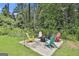 Cozy backyard fire pit area with colorful Adirondack chairs for outdoor relaxation at 110 Sunflower St, Tyrone, GA 30290
