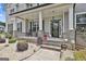 Welcoming front porch with rocking chairs, a decorative wreath, and charming brick details at 110 Sunflower St, Tyrone, GA 30290