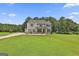 Beautifully landscaped front yard of a two-story home with lush greenery and a long driveway at 110 Sunflower St, Tyrone, GA 30290