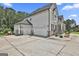 Spacious three-car garage with a long driveway leading up to a charming two-story home at 110 Sunflower St, Tyrone, GA 30290