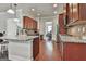 Modern kitchen with granite countertops, stainless steel appliances, and cherry wood cabinets at 110 Sunflower St, Tyrone, GA 30290