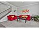 Cozy living room with a comfortable red sofa and a decorative fireplace at 110 Sunflower St, Tyrone, GA 30290