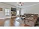 Cozy living room with a stone fireplace, a large TV, and a plush brown sectional sofa at 110 Sunflower St, Tyrone, GA 30290