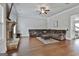 Living room with hardwood floors, fireplace, brown sectional sofa, and ceiling fan at 110 Sunflower St, Tyrone, GA 30290