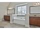 The main bathroom features a large soaking tub between two vanities and a window at 110 Sunflower St, Tyrone, GA 30290