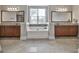 The main bathroom features a large soaking tub between two vanities and a window at 110 Sunflower St, Tyrone, GA 30290