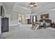 Large main bedroom with a tray ceiling, a bench with stairs for pets, and multiple windows at 110 Sunflower St, Tyrone, GA 30290