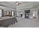 An open main bedroom with a screen room divider, ceiling fan, and doorway to another room at 110 Sunflower St, Tyrone, GA 30290