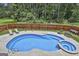 Refreshing backyard pool and spa surrounded by a concrete patio and lush landscaping at 110 Sunflower St, Tyrone, GA 30290