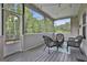 Relaxing screened porch with wooden flooring and wicker furniture, perfect for outdoor enjoyment at 110 Sunflower St, Tyrone, GA 30290