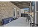 Screened porch featuring a brick wall, outdoor furniture, and a glimpse of the backyard at 110 Sunflower St, Tyrone, GA 30290
