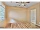 This bedroom features a ceiling fan, neutral walls, wood floors, and a window with blinds at 747 Gardenside Cir, Marietta, GA 30067