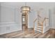 Inviting dining area with updated light fixture, wood floors, and staircase access, perfect for gatherings and daily meals at 747 Gardenside Cir, Marietta, GA 30067