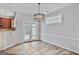 Bright dining area with modern light fixture, wainscoting, and French doors that lead to a patio or backyard space at 747 Gardenside Cir, Marietta, GA 30067