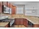Stylish kitchen features granite counters, tile backsplash, and stainless steel appliances, perfect for any home chef at 747 Gardenside Cir, Marietta, GA 30067