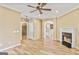 Open-concept living area with stylish light fixture, wood floors, and easy access to the kitchen and staircase at 747 Gardenside Cir, Marietta, GA 30067