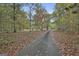 Long driveway leading to the brick home, offering a sense of privacy and seclusion surrounded by trees at 3530 Highway 81 W, Hampton, GA 30228