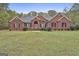 Charming single-story brick home with a well-manicured front lawn and mature landscaping at 3530 Highway 81 W, Hampton, GA 30228