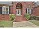Close-up view of the front entrance, showcasing the brick steps and decorative glass door at 3530 Highway 81 W, Hampton, GA 30228