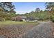Spacious brick home with an attached three car garage, ample parking and nestled in mature trees at 3530 Highway 81 W, Hampton, GA 30228