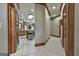 Hallway with tile flooring offers a view into the kitchen with stainless steel appliances at 3530 Highway 81 W, Hampton, GA 30228