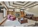 Comfortable living room featuring a stone fireplace, a coffered ceiling, and neutral carpeting at 3530 Highway 81 W, Hampton, GA 30228