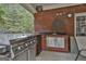 Outdoor grilling station with stainless steel grill, sink and beverage cooler on a brick patio at 3530 Highway 81 W, Hampton, GA 30228
