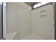 Shower stall with a white surround, corner seat and convenient shelving at 3530 Highway 81 W, Hampton, GA 30228