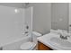 Bright bathroom featuring a white tub and shower combo, toilet, and vanity with sink at 7770 Hana Court Ct, Jonesboro, GA 30236