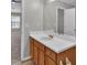 Bathroom vanity with wood cabinets, white countertop, and large mirror at 7770 Hana Court Ct, Jonesboro, GA 30236
