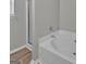Modern bathroom featuring a large tub, a separate glass-enclosed shower, and neutral decor at 7770 Hana Court Ct, Jonesboro, GA 30236