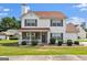 Charming two-story home with a well-manicured lawn and inviting front porch, enhancing its curb appeal at 7770 Hana Court Ct, Jonesboro, GA 30236