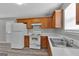 Kitchen with white appliances, oak cabinets, laminate countertops and a view into the living area at 7770 Hana Court Ct, Jonesboro, GA 30236
