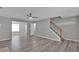 View of a well-lit living room featuring hardwood floors, ceiling fan, staircase, and neutral walls at 7770 Hana Court Ct, Jonesboro, GA 30236