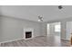 Open-concept living room featuring a fireplace, ceiling fan, and hard surface floors at 7770 Hana Court Ct, Jonesboro, GA 30236