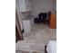 Cozy basement area with tile flooring, storage cabinets, and chair at 5840 Butner Rd, South Fulton, GA 30349