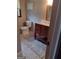 Bathroom showcases a vanity with a framed mirror, tiled floor, toilet, and decorative wall art at 5840 Butner Rd, South Fulton, GA 30349