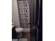 Bathroom with toilet, vanity, and shower behind patterned curtain at 5840 Butner Rd, South Fulton, GA 30349